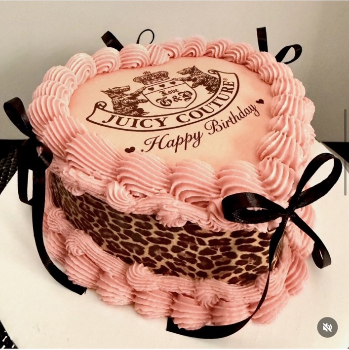 Pink buttercream cake with leopard print and black ribbon accents