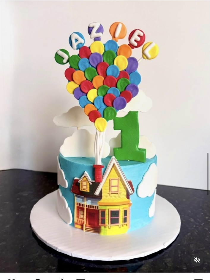 Colorful Up-inspired cake with balloon topper and a bright little house